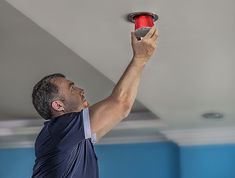 a man holding a red object up in the air