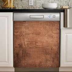 a dishwasher in a kitchen with white cabinets