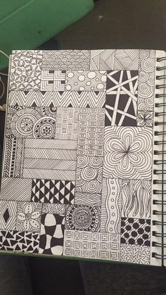 an open notebook with black and white designs on it