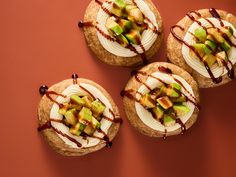 three desserts with fruit and chocolate drizzled on the top are shown