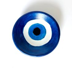 a blue and white bowl with an eye on it