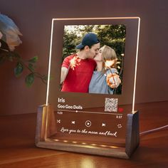 an illuminated photo frame with a couple kissing