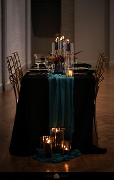 the table is set with candles and place settings for two people to sit down at