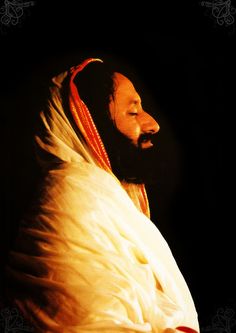 a man with a beard wearing a white blanket