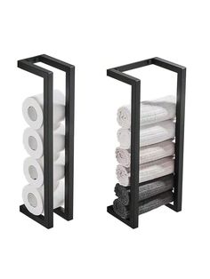 two black racks holding toilet paper and rolls