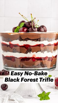 a layered cake with cherries and whipped cream