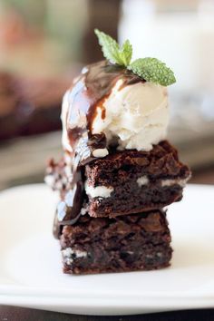 three brownies with ice cream and mint on top