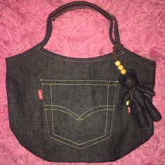 Entire Purse Is Made From Levi’s Jeans Material. With Genuine Leather Handles Sturdy Bottom Snap-On Button For The Opening And A Beautiful Brass Zipper That Runs Smoothly On The Inside Wonderful Fabric Lining And A Logo Bear Carrying A Purse Completely Made Of Levi Jean Material Hanging From The Purse! Jean Material, Levi’s Jeans, Jeans Material, Leather Handles, A Logo, Levis Jeans, Leather Handle, Blue Gold, Levi's