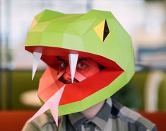 a person wearing a paper mask with the words snake / cobra mask diy and paper craft ideas