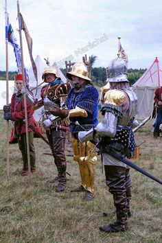 two men dressed in medieval armor standing next to each other