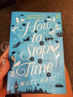 a person holding up a book in their hand with the title how to stop time written on it