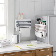 a kitchen counter with two rolls of toilet paper on it