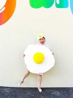 a woman is posing with a fried egg costume