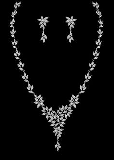 a necklace and earring set with leaves