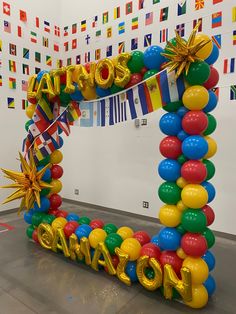 an arch made out of balloons with the words happy new year spelled in large letters