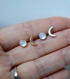 High quality artisan handmade moon phase crescent  moonstone silver earrings. They are definitely one-of-a-kind mismatched earrings! Moon phase stud earrings are handcrafted from solid sterling silver. This Set of two earrings consists of a crescent moon and Natural Rainbow Moonstone full moon. These boho-style earrings are stylish and easy to wear. With their celestial theme, they would make a lovely gift for her. Wear as a matching set, or mix and match styles for an on-trend look. FEATURES: - The crescent moon stud earring has a slightly brushed texture. Size 7 mm x 2 mm.  - Full moon stud made of  AAA quality Rainbow Moonstone cabochon bezel set for security and luxury     look.     Weight of the stone 0.9 Ct, Size of the stone 5 mm.  - High-quality bezel set with an excellent craftsma Moonstone Moon Jewelry With Sun And Moon Design, Moonstone Moon-shaped Jewelry With Sun And Moon Design, Moonstone Sun And Moon Design Jewelry, Moon Phase Moonstone Jewelry, Silver Moon Phase Earrings, Crescent Moonstone Earrings With Moon Phase Detail, Crescent Moonstone Earrings With Moon Phase, Silver Spiritual Moon Phase Earrings, Nickel Free Crescent Moonstone Jewelry