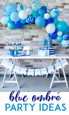 blue ombree party ideas with balloons and streamers on the wall behind it