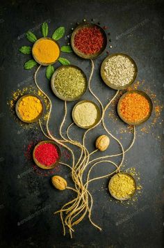 various spices and herbs arranged in bowls on a dark background with space for the text