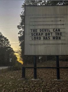 a sign that reads, the devil can scrap but the lord has won on it