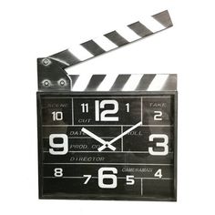 a black and white clock with a movie clapper attached to it's side