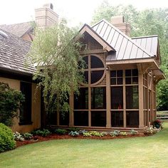 a large house with lots of windows in the front yard