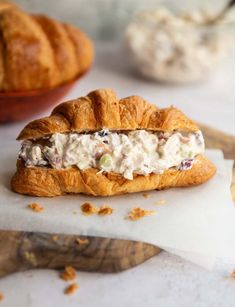 a croissant sandwich with chicken salad on it