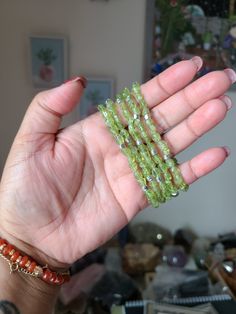 "Peridot crystal bracelet, Birthstone bracelet, Peridot jewelry, Peridot is a crystal of positive power, a talisman for recognizing and honoring the Creator's frequency of Love, the source of all abundance. Used with right intent, it helps expand one's ability to receive from the Universe on all levels of life. Size:  7.1'' Material: AA Peridot nugget, tiny silver plated cube spacers, strong elastic cord. You receive ONE exact bracelet like the ones shown in the pictures. -Handmade By My Crystal Room With High Positive Energy, Love And Intention \"Shines From The Inside Out.\"" Green Gemstone Crystal Bracelet Gift, Spiritual Green Crystal Bracelet For Healing, Green Spiritual Crystal Bracelet For Healing, May Birthstone Crystal Gemstone Bracelet, Green Gemstone Spiritual Bracelets, Green Crystal Bracelet With Gemstone For Healing, Spiritual Green Gemstone Bracelets, Adjustable Peridot Bracelets For Gifts, Green Hand-strung Crystal Necklaces For Healing