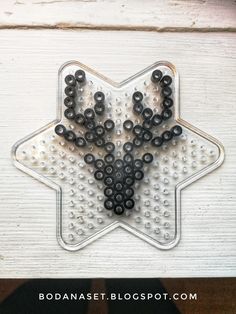 a star shaped object with black beads on it