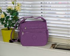 -Multi-pocket Nylon Handbag  Waterproof Shoulder Bag  - lightweight Crossbody Bag - Casual  Work   Travel City Bag Purple -Showerproof material. -Very lightweight, ideal for people who can't carry much weight. -Outer Material: Synthetic -Closure: Zipper -Structure: 1 main compartment with 1 zipped inside pocket, 1 zipped pocket at the back, 3 zipped    pockets in front and 2 bottle slots at the sides. -Size: 26(L)x22(H)x12(W)cm. Fits an iPad. Strap length: 75-140cm. Can be used as a crossbody or shoulder     bag by adjusting the strap. -Useful for: everyday use, travel, holidays, trips. Ideal as a gift for birthdays, Christmas or Mother's Day. Boho Tote Bag, Nylon Shoulder Bag, Boho Tote, Cotton Handbag, Travel City, City Bag, Purple Bags, Day Bag, Gorgeous Bags