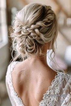 a woman with blonde hair wearing a white dress and braid in her hair is looking out the window