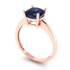 a rose gold ring with an oval blue sapphire stone in the center, on a white background