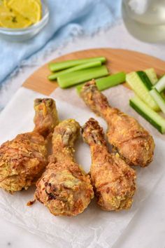 chicken wings with celery sticks and lemon wedges