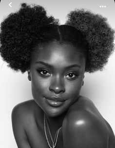 a woman with an afro is posing for the camera