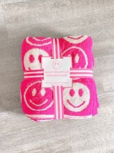 pink and white towels with smiley faces on them