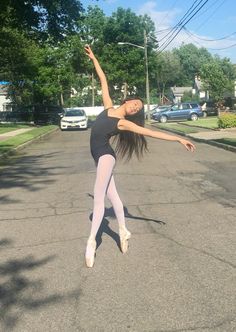 a woman is doing a trick on the street