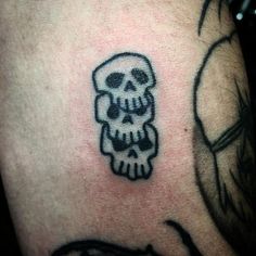 a skull with a hat on it's head is seen in this tattoo design