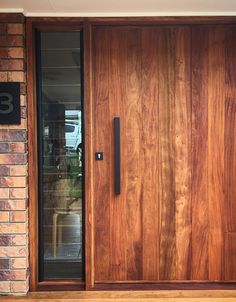 a close up of a wooden door on a brick building