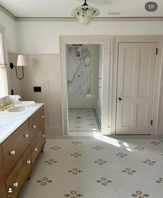 a bathroom with two sinks and a large mirror on the wall next to a door