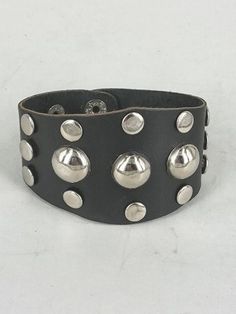 {Constructor} : Handcrafted by me Vasilis, from top quality leather wrap bracelet with studs for arms. {Durable Genuine Leather}: It has a 2 snap closure which allows it to be adjusted. This piece looks beautiful if you wear it solo your hand are not empty. {Dimension}:  * Leather comes in brown,black,dark brown 22cm(L) x 4.3cm(W) weight: 0.100gr {Quantity Structure}: This wrap bracelet with studs is handmade/handcreafted in Greece with greek cow leather , has a  rock/retro/punk style and it is look elegant for all type of people. {Good Helper}: Practical gift for them that loves punk or rock style to yourself, friends,  they will love it. Also we could give for gift for any occasion her birthday, for your Boss ,New Year, Valentine's Day, Mother's Day, Thanksgiving Day, Christmas and other Adjustable Silver Wristband Fashion Accessory, Adjustable Silver Wristband For Fashion, Adjustable Punk Cuff Bracelet, Adjustable Punk Cuff Bracelet With Wrist Strap, Adjustable Metal Wristband Fashion Accessory, Punk Style Silver Cuff Leather Bracelet, Punk Style Silver Leather Cuff Bracelet, Adjustable Metal Wristband, Adjustable Punk Cuff Bracelet For Festival