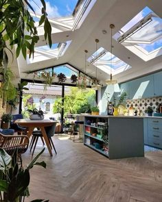 an open kitchen and dining area with skylights