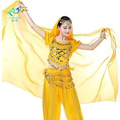 a woman in a yellow belly dance outfit with her arms spread out and hands outstretched