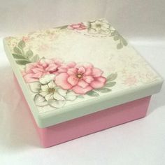 a pink and white box with flowers painted on it