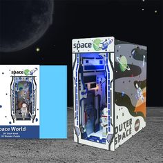 the space shuttle model is in its box on the moon next to it's packaging