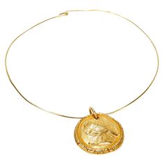 A fine gold necklace after Pablo Picasso. In 14k yellow gold. Depicting a bird in profile. Fashioned after Picasso's terra cotta medallion entitled: Oiseau de Profil (A.R. 91) Marked to the reverse Madoura Empreiente Originale de Picasso. Circa 1950. Together with a later associated 14k gold wire choker neckpiece. Simply a wonderful piece of Picasso inspired jewelry! Date: Mid-20th Century, circa 1950 Overall Condition: It is in overall good, as-pictured, used estate condition. Condition Details: There are light bends to the wire neckpiece. Otherwise, there is some light edge wear, some fine and light surface scratches, and other signs of light wear consistent with age. Fineness: Unmarked for gold fineness. Professionally tests at 14k. Marks: Madoura Empreiente Originale de Picasso Measure Fine Jewelry Necklace With Coin Medallion, Fine Jewelry Necklace With Coin Pendant, Elegant Yellow Gold Coin Necklace With Large Pendant, Luxury Bronze Pendant Necklace, Fine Jewelry Medallion Coin Necklace, Gold Medallion Coin Necklace Fine Jewelry, Yellow Gold Coin Medallion Necklace With Large Pendant, Antique Yellow Gold Necklace With Large Pendant, Picasso Inspired