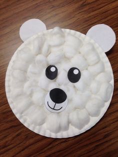 a paper plate with a polar bear made out of marshmallows