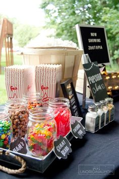 a table topped with lots of candy and popcorn