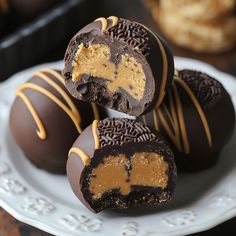 several chocolate covered desserts on a white plate