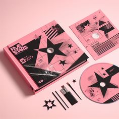 a pink box with black stars on it and other items to make up the package