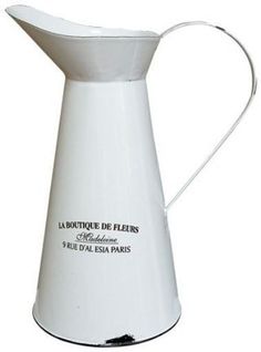 a white ceramic pitcher with the words la boutiquene de fliers written on it