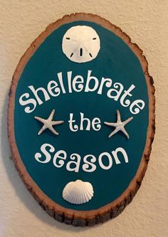 a sign that says shelebrate the season with starfish and seashells